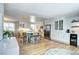 Spacious kitchen featuring white cabinetry, a blue island with seating, and stainless steel appliances at 8581 W Hinsdale Pl, Littleton, CO 80128