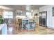 Bright and spacious kitchen with a blue island, modern appliances, and a breakfast bar with seating at 8581 W Hinsdale Pl, Littleton, CO 80128