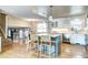 Open kitchen featuring a spacious island with seating, stainless steel appliances, and hardwood floors at 8581 W Hinsdale Pl, Littleton, CO 80128