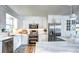 Modern kitchen with stainless steel appliances, white cabinetry, and a sleek countertop at 8581 W Hinsdale Pl, Littleton, CO 80128