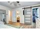 Spacious main bedroom featuring a sliding barn door leading to the ensuite bathroom and walk-in closet at 8581 W Hinsdale Pl, Littleton, CO 80128