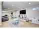 Bright playroom with built-in storage, large mirror, TV, and plenty of room for activities at 8581 W Hinsdale Pl, Littleton, CO 80128