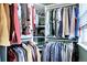 Organized walk-in closet with ample hanging space, shelves, and storage for clothes and accessories at 8581 W Hinsdale Pl, Littleton, CO 80128