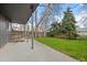 Spacious backyard with mature trees, a concrete patio, and a well-maintained lawn at 1002 Zang St, Golden, CO 80401