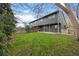 Large grassy backyard with a view of the home's gray exterior and a wooden fence in the background at 1002 Zang St, Golden, CO 80401