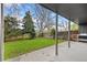 View of the backyard with a concrete patio and lawn area surrounded by mature trees and a wooden fence at 1002 Zang St, Golden, CO 80401
