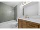 Stylish bathroom with a wood vanity, new fixtures, and tiled shower and tub at 1002 Zang St, Golden, CO 80401