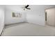Light-filled bedroom with neutral carpet, a modern ceiling fan, and a large window at 1002 Zang St, Golden, CO 80401
