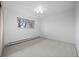 Bright and airy bedroom with neutral carpet, updated lighting and a view to the exterior at 1002 Zang St, Golden, CO 80401