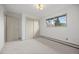 Well lit bedroom with neutral carpet, large window, and closet access at 1002 Zang St, Golden, CO 80401