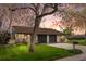 Charming brick home with a well-manicured lawn, mature trees, and a cozy front porch at 1002 Zang St, Golden, CO 80401