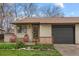 Cozy front porch with red chairs, fresh flowers, and charming curb appeal at 1002 Zang St, Golden, CO 80401