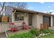 Cozy front porch with red chairs, fresh flowers, and charming curb appeal at 1002 Zang St, Golden, CO 80401