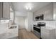 Renovated kitchen boasting light gray cabinets, stainless appliances, and new countertops at 1002 Zang St, Golden, CO 80401