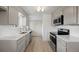 Updated kitchen featuring light gray cabinetry, stainless steel appliances, and quartz countertops at 1002 Zang St, Golden, CO 80401
