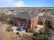 Aerial view of a two-story home with a patio and outdoor seating area at 23101 Timber Spring Ln, Parker, CO 80138