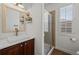 Modern bathroom featuring a vessel sink, sleek vanity, and glass-enclosed shower at 23101 Timber Spring Ln, Parker, CO 80138