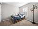 Bedroom featuring a bed, window with blinds, and a stylish modern floor lamp at 23101 Timber Spring Ln, Parker, CO 80138