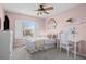 Bedroom with a ceiling fan, window with blinds, twin bed, desk and white accents at 23101 Timber Spring Ln, Parker, CO 80138