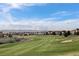 Picturesque view of a golf course with mountains in the distance at 23101 Timber Spring Ln, Parker, CO 80138