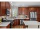 Well-equipped kitchen with stainless steel appliances, stone backsplash and countertops at 23101 Timber Spring Ln, Parker, CO 80138