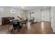 Bright and airy living room featuring an adjacent dining area with hardwood floors and neutral tones at 23101 Timber Spring Ln, Parker, CO 80138