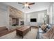 Inviting living room featuring a stone fireplace, wood floors, and a comfortable seating area at 23101 Timber Spring Ln, Parker, CO 80138