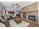 Spacious living room with a striking stone fireplace, seamless transition to the dining and kitchen areas at 23101 Timber Spring Ln, Parker, CO 80138