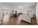 Bright living room with hardwood floors, plantation shutters, and a seamless flow to the dining area at 23101 Timber Spring Ln, Parker, CO 80138