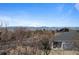 Scenic view of neighborhood homes and mountains in the distance on a clear day with blue sky at 23101 Timber Spring Ln, Parker, CO 80138