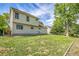 Expansive backyard featuring lush green grass, mature trees, and a charming home exterior at 9946 Harrison St, Thornton, CO 80229
