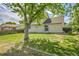 A large backyard with lawn and a home's exterior that features sliding glass doors at 9946 Harrison St, Thornton, CO 80229