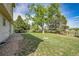 A fenced yard with mature trees at 9946 Harrison St, Thornton, CO 80229