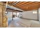 Unfinished basement with fireplace, exposed beams, and visible ductwork at 9946 Harrison St, Thornton, CO 80229