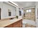 Bathroom featuring a granite vanity, ample lighting, and a shower-tub with tiled surround at 9946 Harrison St, Thornton, CO 80229