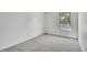 Bright bedroom with fresh, clean carpet and a window bringing in natural light at 9946 Harrison St, Thornton, CO 80229