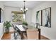 Dining room features a large window, hardwood floors and stylish furnishings at 9946 Harrison St, Thornton, CO 80229