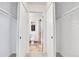 Hallway closet leading into a bathroom with tile floors and tiled shower at 9946 Harrison St, Thornton, CO 80229