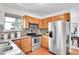 Spacious kitchen with stainless steel appliances, granite countertops, and tile backsplash at 9946 Harrison St, Thornton, CO 80229