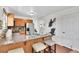Open kitchen featuring a breakfast bar with seating, stainless steel appliances, and granite countertops at 9946 Harrison St, Thornton, CO 80229