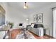 Inviting living room with vaulted ceiling, neutral tones and hardwood floors at 9946 Harrison St, Thornton, CO 80229