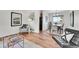 Open-concept living room featuring hardwood floors, stylish furniture and a view into dining area at 9946 Harrison St, Thornton, CO 80229
