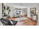 Well-lit living room featuring wood floors and modern furnishings at 9946 Harrison St, Thornton, CO 80229