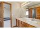 Bathroom with double sinks, offering ample counter space and separate doors to the shower and bedroom at 1348 Lawson Ave, Erie, CO 80516