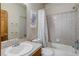 Full bathroom featuring tiled walls, standard bathtub and shower, and single sink vanity at 1348 Lawson Ave, Erie, CO 80516