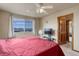 Cozy bedroom with a large window offering stunning views, and a ceiling fan for comfort at 1348 Lawson Ave, Erie, CO 80516