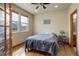 Bedroom featuring hardwood floors, large windows for natural light, and a full-sized bed at 1348 Lawson Ave, Erie, CO 80516