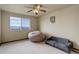 Bright bedroom with a beanbag, a daybed, and a window overlooking scenic mountain views at 1348 Lawson Ave, Erie, CO 80516