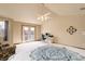 Spacious bedroom with vaulted ceilings, fan, and outdoor access, perfect for relaxation and work at 1348 Lawson Ave, Erie, CO 80516