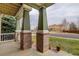 Welcoming covered porch with brick columns and a cozy neighborhood view at 1348 Lawson Ave, Erie, CO 80516